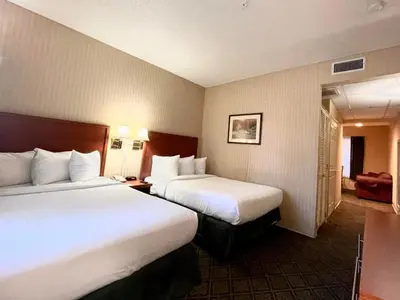 a hotel room with two beds in a room at Park Suites Hotel in South El Monte