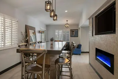 a kitchen with a bar and a fireplace at City Express by Marriott Manhattan Beach in Manhattan Beach