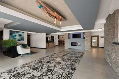 a large living room with a couch and a fireplace at City Express by Marriott Manhattan Beach in Manhattan Beach