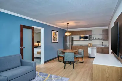 a kitchen and living room with a table and a couch at DoubleTree by Hilton Chatsworth in Chatsworth