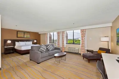 a large hotel room with a bed and a couch at Doubletree by Hilton Whittier in Whittier
