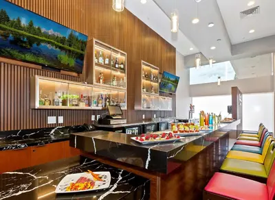 a restaurant with a bar with colorful chairs at Doubletree by Hilton Whittier in Whittier