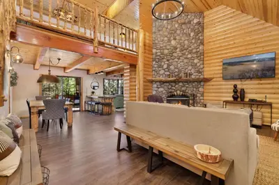 a living room with a stone fireplace and a couch at Dreams of Summit-1120 by Big Bear Vacations in Big Bear Lake