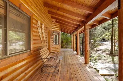 a porch of a cabin with two chairs on it at Dreams of Summit-1120 by Big Bear Vacations in Big Bear Lake