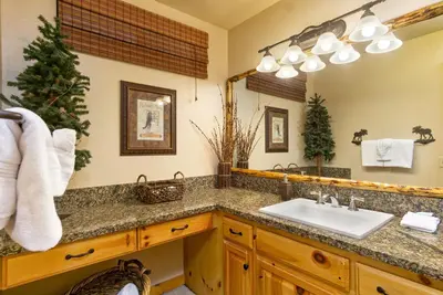 a bathroom with a sink and a mirror at All About Fun-1149 by Big Bear Vacations in Big Bear Lake