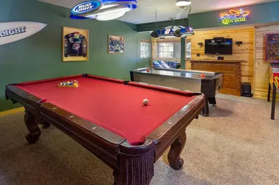 a billiard room with a pool table and a tv at All About Fun-1149 by Big Bear Vacations in Big Bear Lake