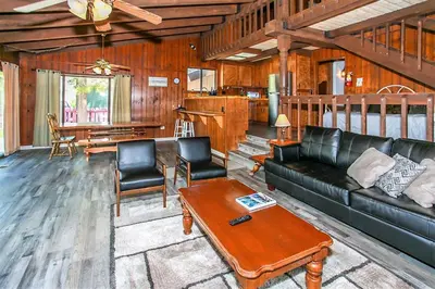 a living room with a couch and a table at Lakeview Fishing House-121 by Big Bear Vacations in Big Bear Lake
