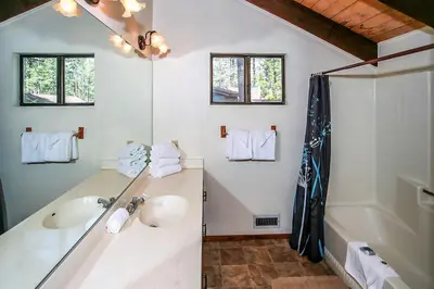 a bathroom with two sinks and a tub at Lakeview Fishing House-121 by Big Bear Vacations in Big Bear Lake