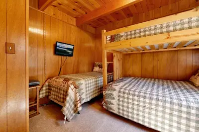 a bedroom with two bunk beds in a cabin at Moose Creek Chalet-1237 by Big Bear Vacations in Big Bear Lake