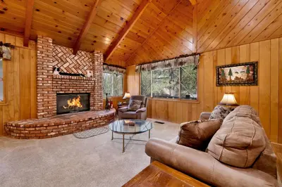 a living room with a couch and a fireplace at Moose Creek Chalet-1237 by Big Bear Vacations in Big Bear Lake