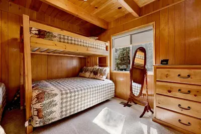 a bedroom with a bunk bed and a dresser at Moose Creek Chalet-1237 by Big Bear Vacations in Big Bear Lake