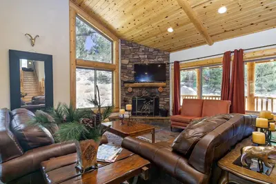 a living room with leather furniture and a fireplace at Eagle Ridge Views-1648 by Big Bear Vacations in Big Bear Lake