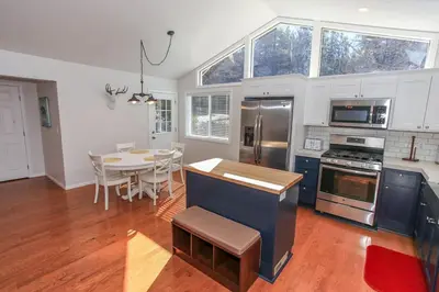 a kitchen with a table and a dining room at Mountain Modern-1743 by Big Bear Vacations in Big Bear Lake