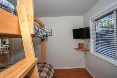 a room with a bunk bed and a flat screen tv at Mountain Modern-1743 by Big Bear Vacations in Big Bear Lake