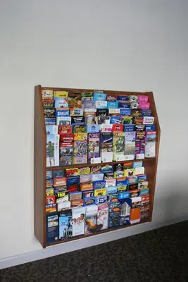 a book shelf filled with books on a wall at Queens Inn Anaheim in Anaheim