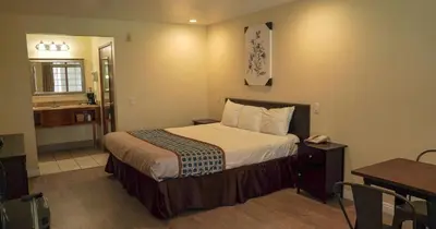 a hotel room with a bed and a bathroom at Country Inn Ontario in Ontario