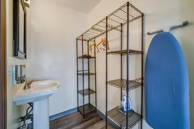 a bathroom with a sink and a surfboard on the wall at 24 Hours Motel in Los Angeles