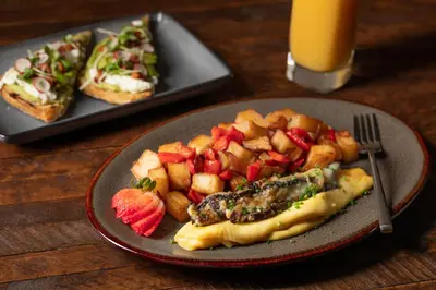 a plate of food on a table with a plate of fruit at Bear Springs Hotel in Highland