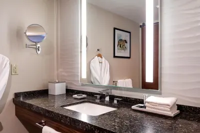 a bathroom with a sink and a large mirror at Bear Springs Hotel in Highland