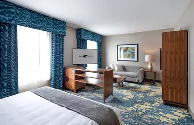 a hotel room with a bed and a desk at Bear Springs Hotel in Highland