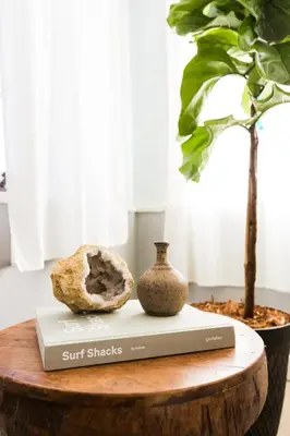 a book and a vase sitting on a table at The Venice Beach House in Los Angeles