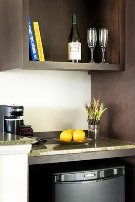 a kitchen with two glasses of wine and a plate of lemons at ALO Hotel by Ayres, Orange in Anaheim