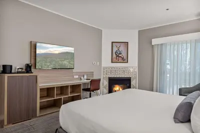 a hotel room with a bed and a fireplace at Chateau Big Bear Boutique Hotel, BW Signature Collection in Big Bear Lake