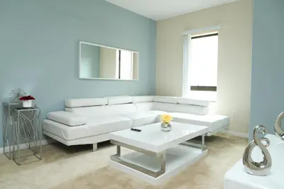 a living room with a white couch and a table at Amazing Apartments near the grove in Los Angeles