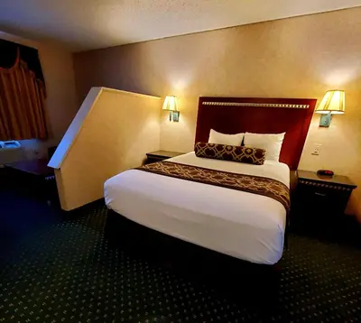 a bedroom with a large bed in a hotel room at Triplodge of Santa Clarita in Santa Clarita