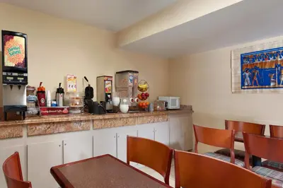 a restaurant with a bar with tables and chairs at Triplodge of Santa Clarita in Santa Clarita