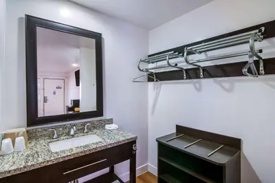 a bathroom with a sink and a mirror at Motel 6 Monterey Park in Monterey Park