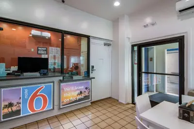 a waiting area of a hotel with a sign at Motel 6 Monterey Park in Monterey Park
