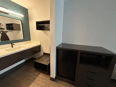 a bathroom with a sink and a mirror at Studio 6 Suites Gardena, CA in Gardena