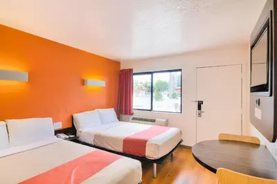 a hotel room with two beds and a table at Motel 6-Camarillo, CA in Camarillo