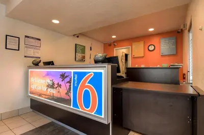 a television in a waiting room with a number six at Motel 6-Westminster, CA - South - Long Beach Area in Westminster
