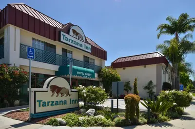 a hotel with a sign in front of it at Tarzana Inn in Tarzana