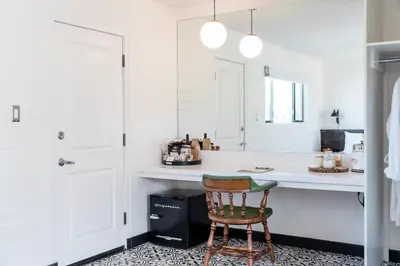 a white kitchen with a chair and a counter at Cuyama Buckhorn in New Cuyama
