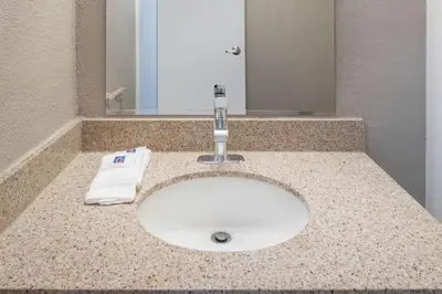 a sink in a bathroom with a towel on it at Motel 6-Fontana, CA in Fontana
