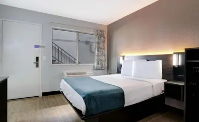 a hotel room with a large bed and a window at Motel 6-Bakersfield, CA - South in Bakersfield