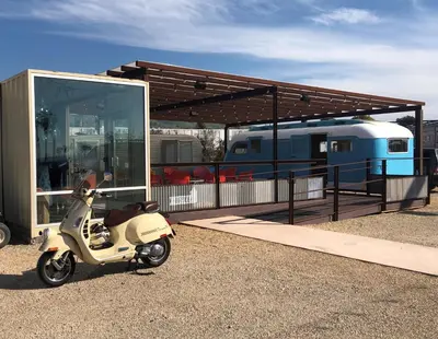 a scooter parked in front of a building with a train at Waypoint Ventura in Ventura