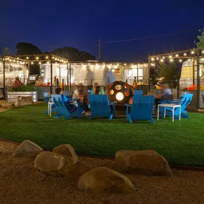 a group of people sitting in chairs on a lawn at night at Waypoint Ventura in Ventura