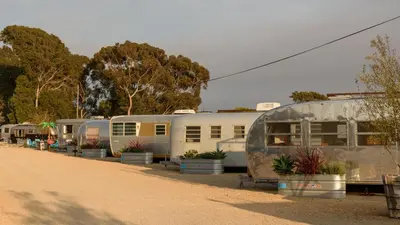 a row of trailers parked in a parking lot at Waypoint Ventura in Ventura