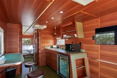 a kitchen with wood paneled walls and a kitchen with a microwave at Waypoint Ventura in Ventura