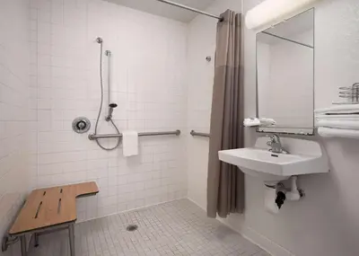 a white bathroom with a sink and a shower at Motel 6-Carpinteria, CA - Santa Barbara - North in Carpinteria