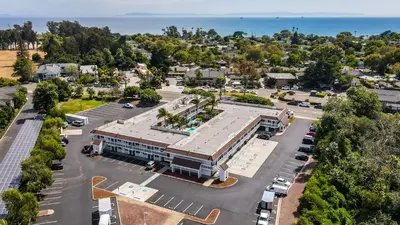 an aerial view of a building with a parking lot at Motel 6-Carpinteria, CA - Santa Barbara - North in Carpinteria