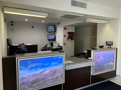 an office with a large computer monitor on a desk at Vagabond Inn Sylmar in Sylmar