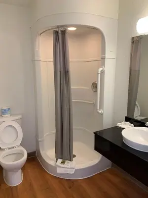 a bathroom with a shower and a toilet and a sink at Vagabond Inn Sylmar in Sylmar