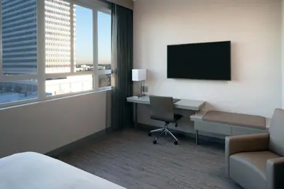 a hotel room with a desk and a television at AC Hotel by Marriott Beverly Hills in Los Angeles