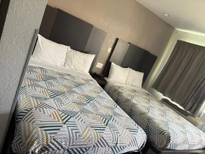 a hotel room with two beds in a room at Motel 6-San Bernardino, CA - North in Serrano Village