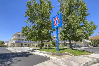 a sign for a hotel on the side of a street at Motel 6-San Bernardino, CA - North in Serrano Village